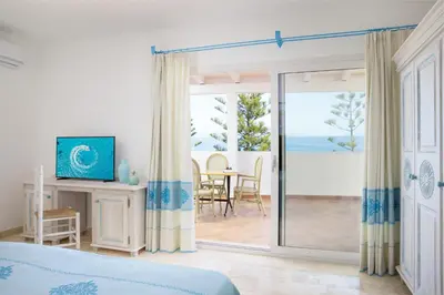Letto o letti in una camera di Nicolaus Club Quattro Lune Resort