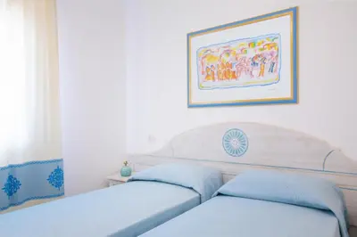Letto o letti in una camera di Nicolaus Club Quattro Lune Resort