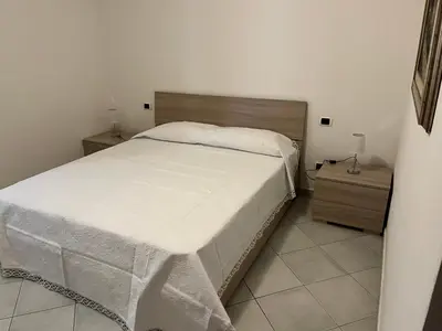 Letto o letti in una camera di Ampio bilocale