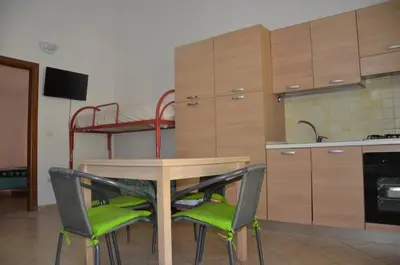 Cucina o angolo cottura di FAN SARD Villetta 10 posti letto FBU-ZAN01