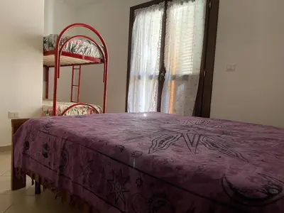 Letto o letti in una camera di FAN SARD Villetta 10 posti letto FBU-ZAN01