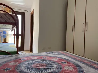Letto o letti in una camera di FAN SARD Villetta 10 posti letto FBU-ZAN01