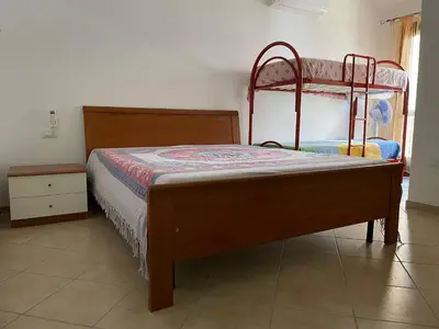 Letto o letti in una camera di FAN SARD Villetta 10 posti letto FBU-ZAN02