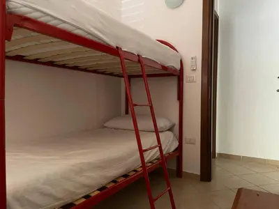 Letto o letti in una camera di FAN SARD Villetta 10 posti letto FBU-ZAN02